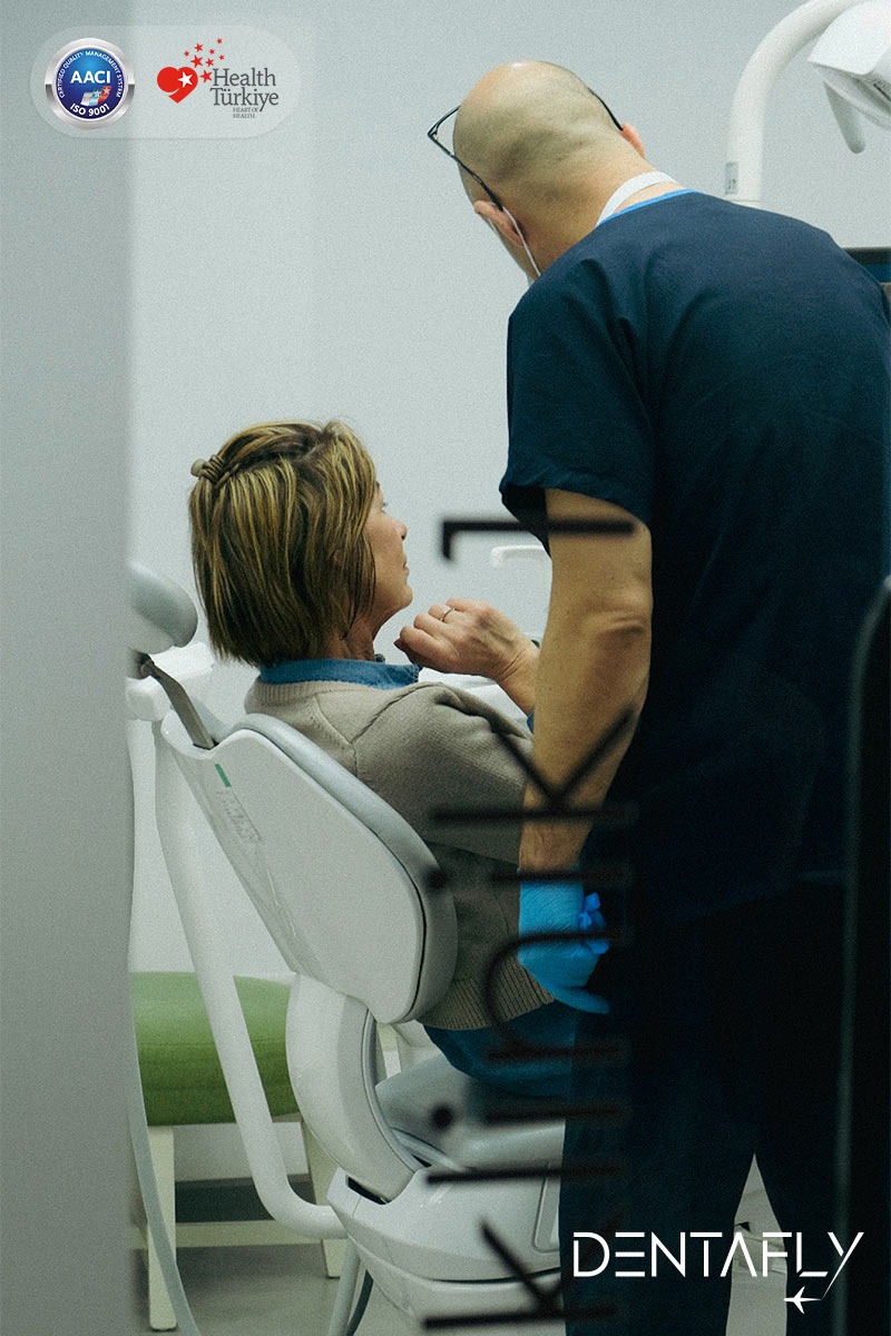 Dr. Burak Gökdeniz patient consultation with personalized care at Dentafly Antalya