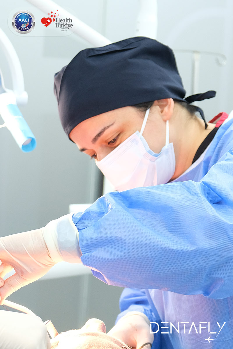 Asst. Prof. Dt. Gülen Kamak dental implant periodontist providing patient care at Dentafly Antalya — Lara Antalya Turkey clinic