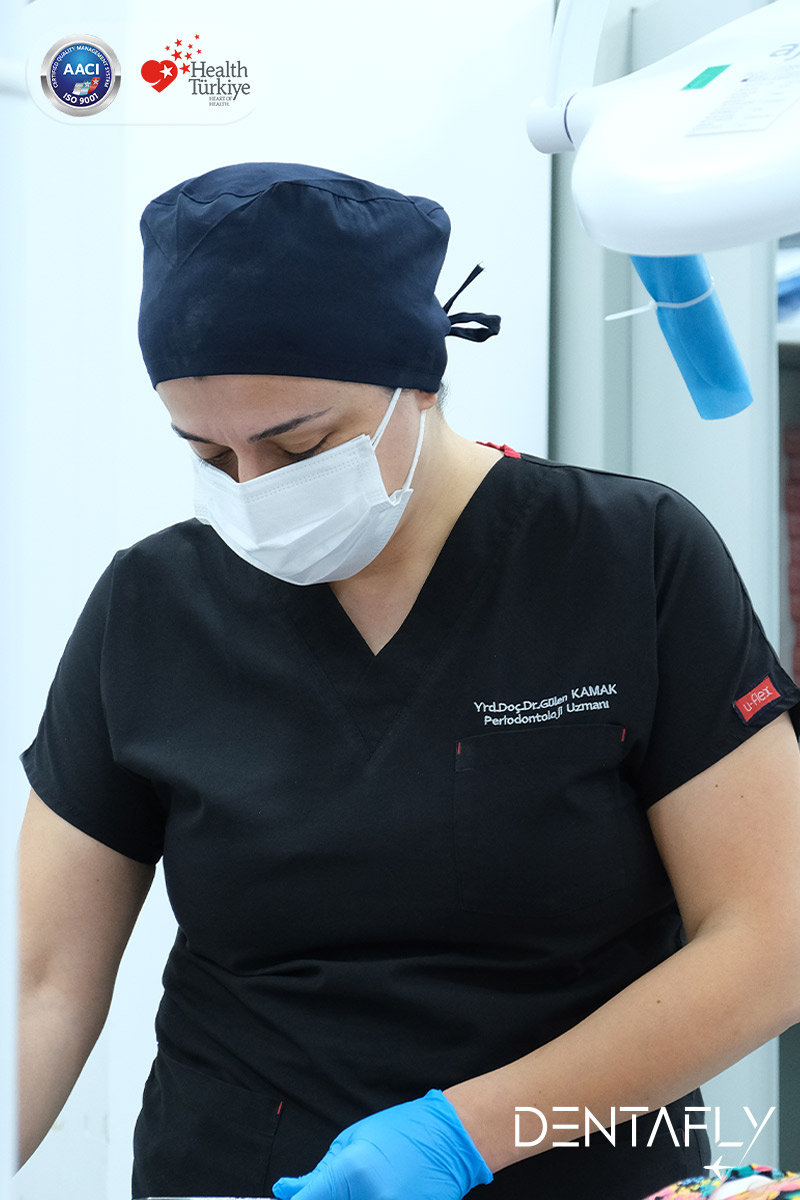 Asst. Prof. Dt. Gülen Kamak periodontology specialist in clinical attire at Dentafly Antalya — Lara Antalya periodontist clinic