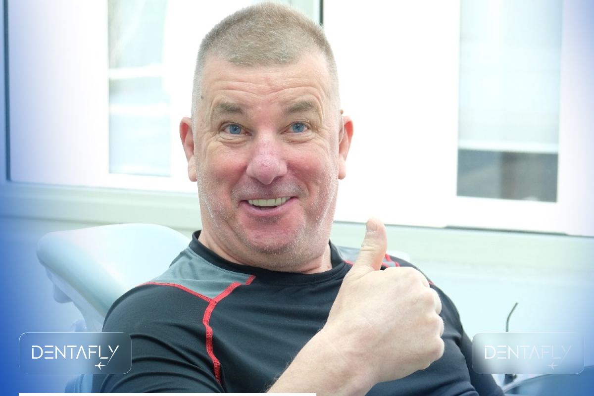 Happy UK patient at Dentafly Antalya giving thumbs up after dental implant treatment satisfaction